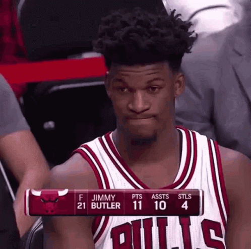 A Basketball Player Wearing A Bulls Jersey Is Sitting In The Stands Watching A Game . GIF