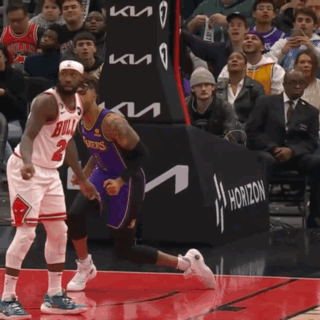 A Basketball Player Wearing A Bulls Jersey Runs Towards Another Player Wearing A Lakers Jersey GIF
