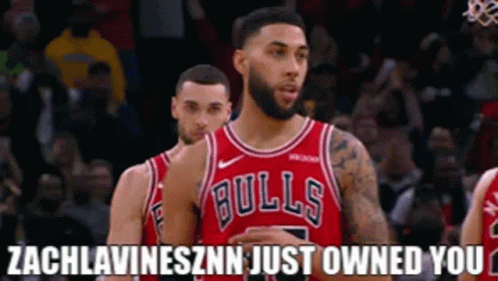 A Basketball Player Wearing A Bulls Jersey Stands Next To Another Player . GIF
