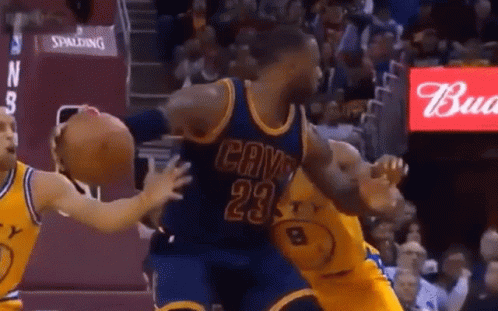 A Basketball Player Wearing A Cavs Jersey Is Being Blocked By A Player Wearing A Golden State Warriors Jersey GIF