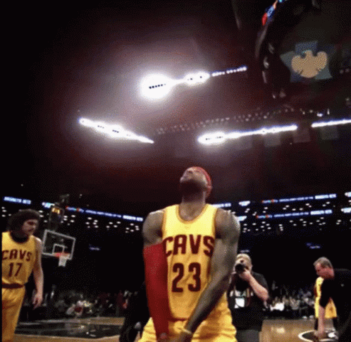 A Basketball Player Wearing A Cavs Jersey Is Jumping In The Air GIF