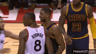 A Basketball Player Wearing A Cavs Jersey Is Talking To Another Player GIF