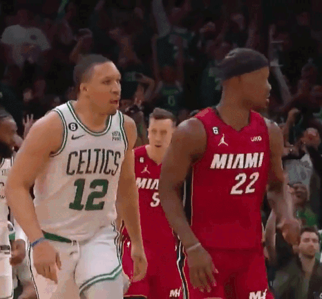 A Basketball Player Wearing A Celtics Jersey Stands Next To Another Player Wearing A Miami Jersey . GIF