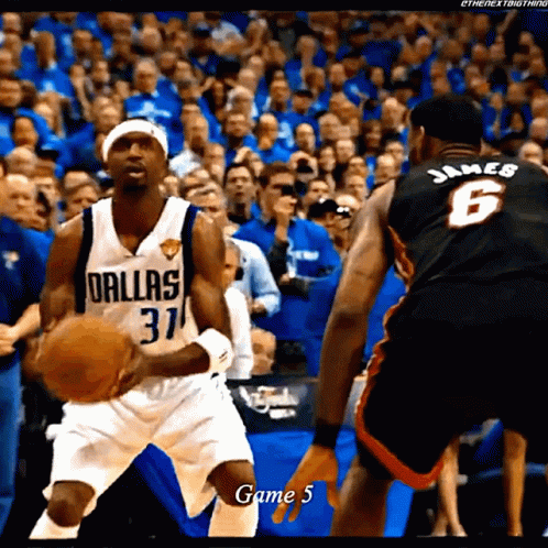 A Basketball Player Wearing A Dallas Jersey Holds The Ball GIF