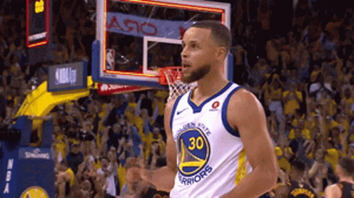 A Basketball Player Wearing A Golden State Warriors Jersey Celebrates GIF