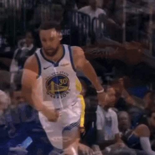 A Basketball Player Wearing A Golden State Warriors Jersey Is Dribbling The Ball GIF
