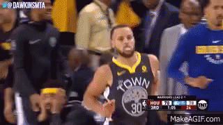 A Basketball Player Wearing A Golden State Warriors Jersey Is Standing In Front Of A Crowd Of People . GIF
