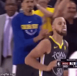 A Basketball Player Wearing A Golden State Warriors Jersey Stands In Front Of A Crowd During A Game . GIF