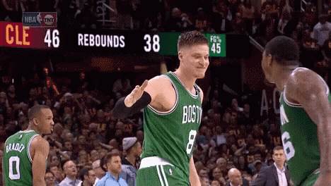 A Basketball Player Wearing A Green Jersey That Says Boston Is Giving Another Player A High Five GIF