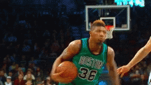 A Basketball Player Wearing A Green Jersey With Boston 36 On It GIF