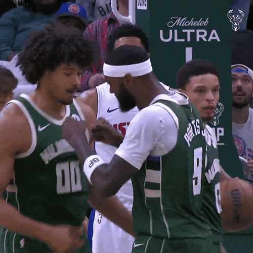 A Basketball Player Wearing A Green Jersey With The Number 9 On It GIF
