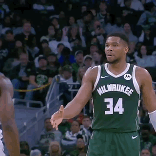 A Basketball Player Wearing A Green Milwaukee Jersey GIF