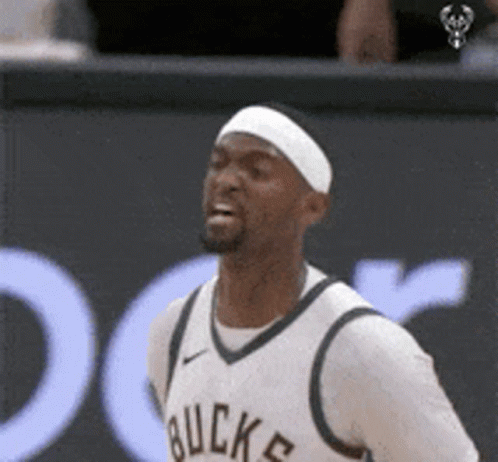 A Basketball Player Wearing A Headband And A White Jersey With The Word Buck On It GIF