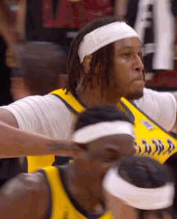 A Basketball Player Wearing A Headband And A Yellow Jersey GIF