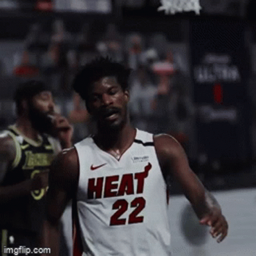 A Basketball Player Wearing A Heat 22 Jersey Runs On The Court GIF