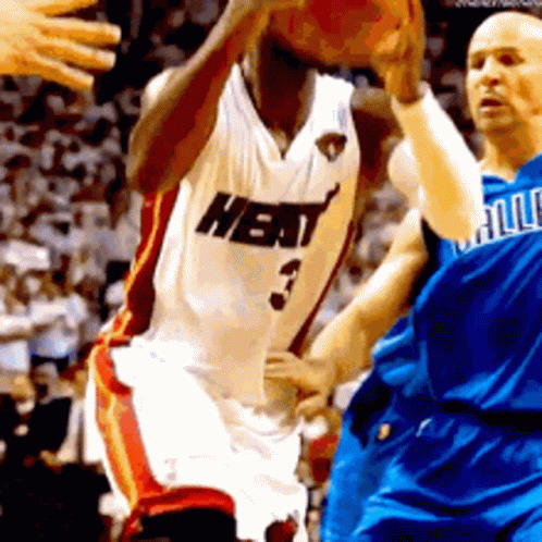 A Basketball Player Wearing A Heat Jersey Is Dribbling The Basketball GIF