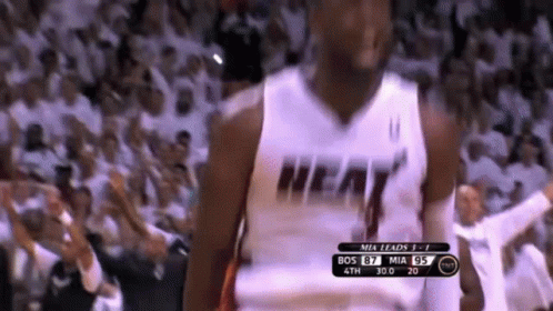 A Basketball Player Wearing A Heat Jersey Is Standing In Front Of A Crowd GIF