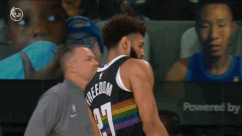 A Basketball Player Wearing A Jersey That Says Freedom GIF