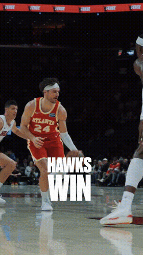 A Basketball Player Wearing A Jersey That Says Hawks Win GIF