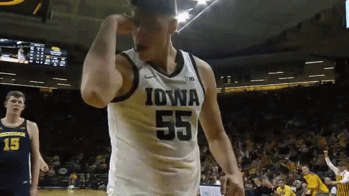 A Basketball Player Wearing A Jersey That Says Iowa On It GIF