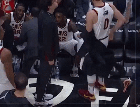 A Basketball Player Wearing A Jersey That Says Love Is Being Helped Off The Court GIF