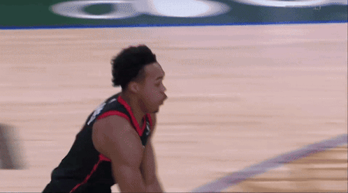 a basketball player wearing a jersey that says ' raptors ' on it