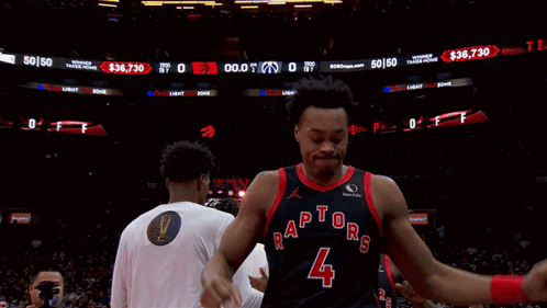 a basketball player wearing a jersey that says raptors on it