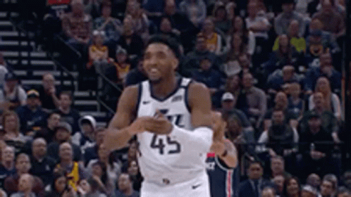A Basketball Player Wearing A Jersey With The Number 45 On It GIF