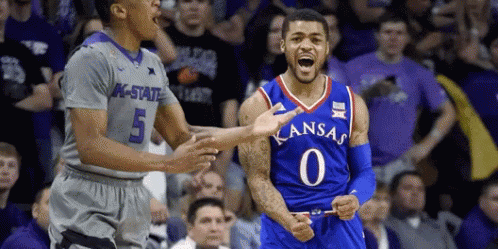 A Basketball Player Wearing A Kansas Jersey Celebrates With His Teammates GIF