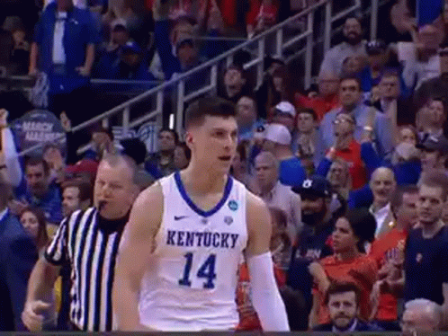 A Basketball Player Wearing A Kentucky Jersey Is Standing On The Court . GIF