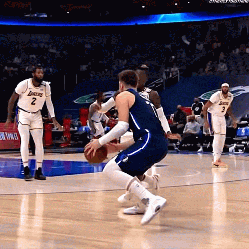 A Basketball Player Wearing A Lakers Jersey Is Dribbling The Ball GIF