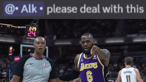a basketball player wearing a lakers jersey is pointing at the camera