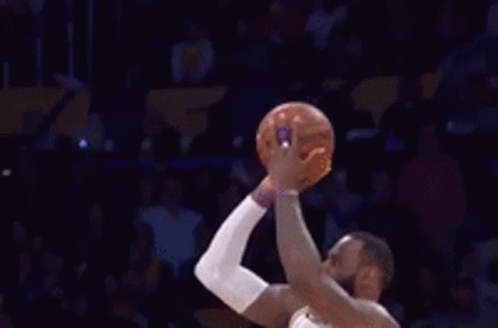 A Basketball Player Wearing A Lakers Jersey Is Standing In Front Of A Crowd . GIF