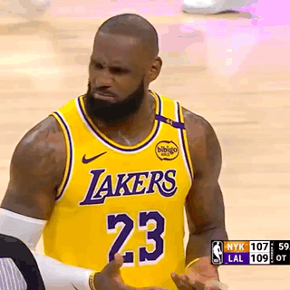 A Basketball Player Wearing A Lakers Jersey Is Talking To A Referee . GIF