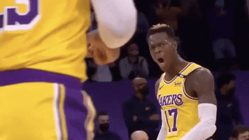 A Basketball Player Wearing A Lakers Jersey Is Yelling At Another Player . GIF