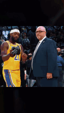 A Basketball Player Wearing A Lakers Jersey Stands Next To A Man In A Suit GIF