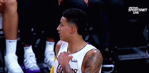 A Basketball Player Wearing A Lakers Jersey With A Wish Logo On His Chest GIF