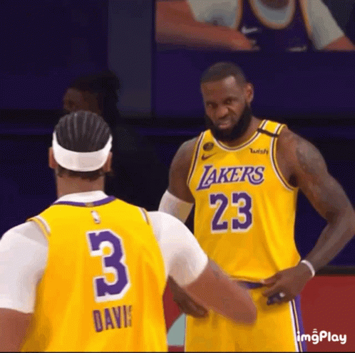 a basketball player wearing a lakers jersey with the number 23 on it