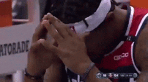 A Basketball Player Wearing A Mask And A Gatorade Bottle In The Background GIF