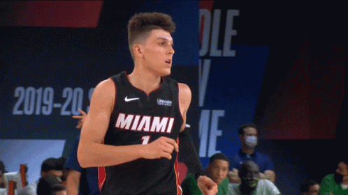A Basketball Player Wearing A Miami Jersey Is Running On The Court GIF