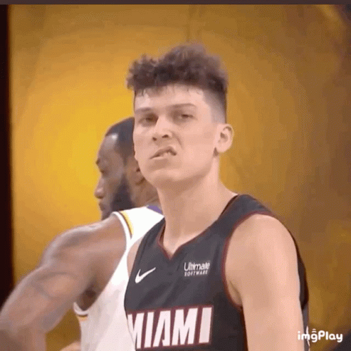 A Basketball Player Wearing A Miami Jersey Looks At The Camera GIF