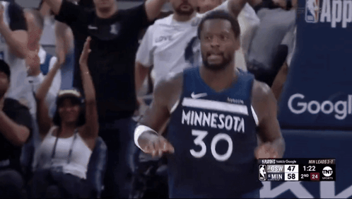 A Basketball Player Wearing A Minnesota 30 Jersey Stands In Front Of A Crowd GIF