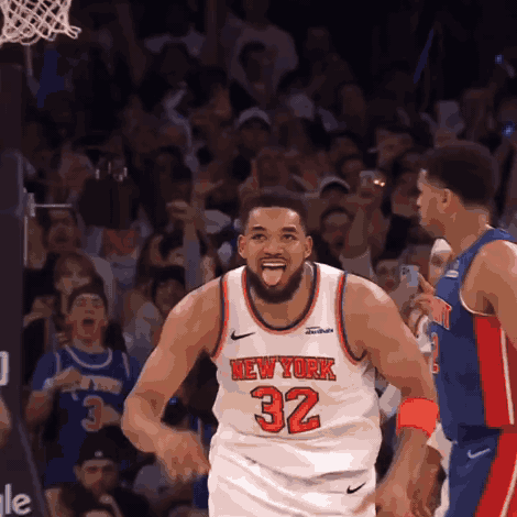 A Basketball Player Wearing A New York 32 Jersey Stands In Front Of A Crowd GIF