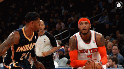 A Basketball Player Wearing A New York Jersey Looks At Another Player GIF
