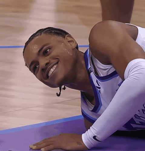 A Basketball Player Wearing A Nike Sleeve Is Smiling On The Court GIF
