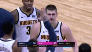 A Basketball Player Wearing A Nuggets Jersey Gives A High Five GIF