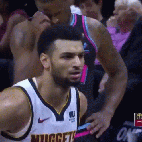 A Basketball Player Wearing A Nuggets Jersey Looks At The Camera GIF