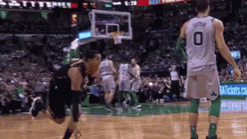 A Basketball Player Wearing A Number 0 Jersey Is Kneeling On The Court . GIF