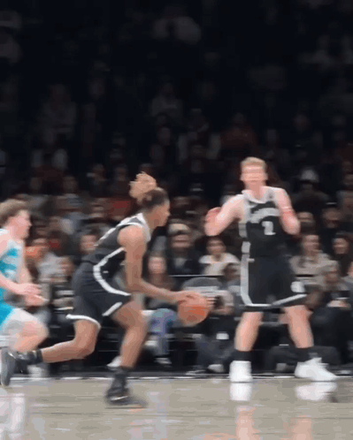A Basketball Player Wearing A Number 1 Jersey Dribbles The Ball GIF