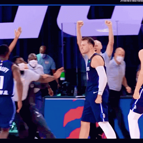 a basketball player wearing a number 1 jersey stands with his fist in the air